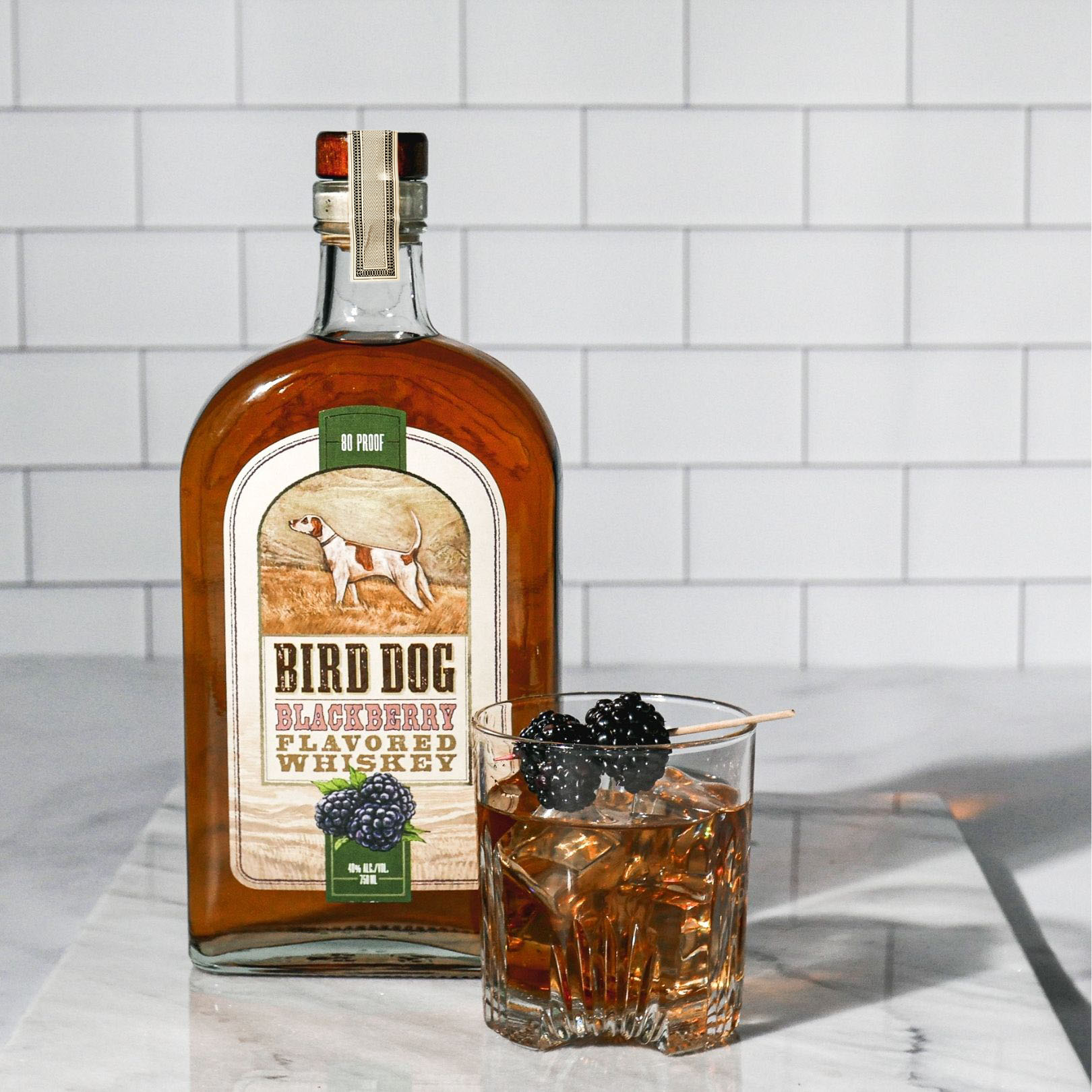 Bottle of Bird Dog Blackberry Whiskey with a Cocktail