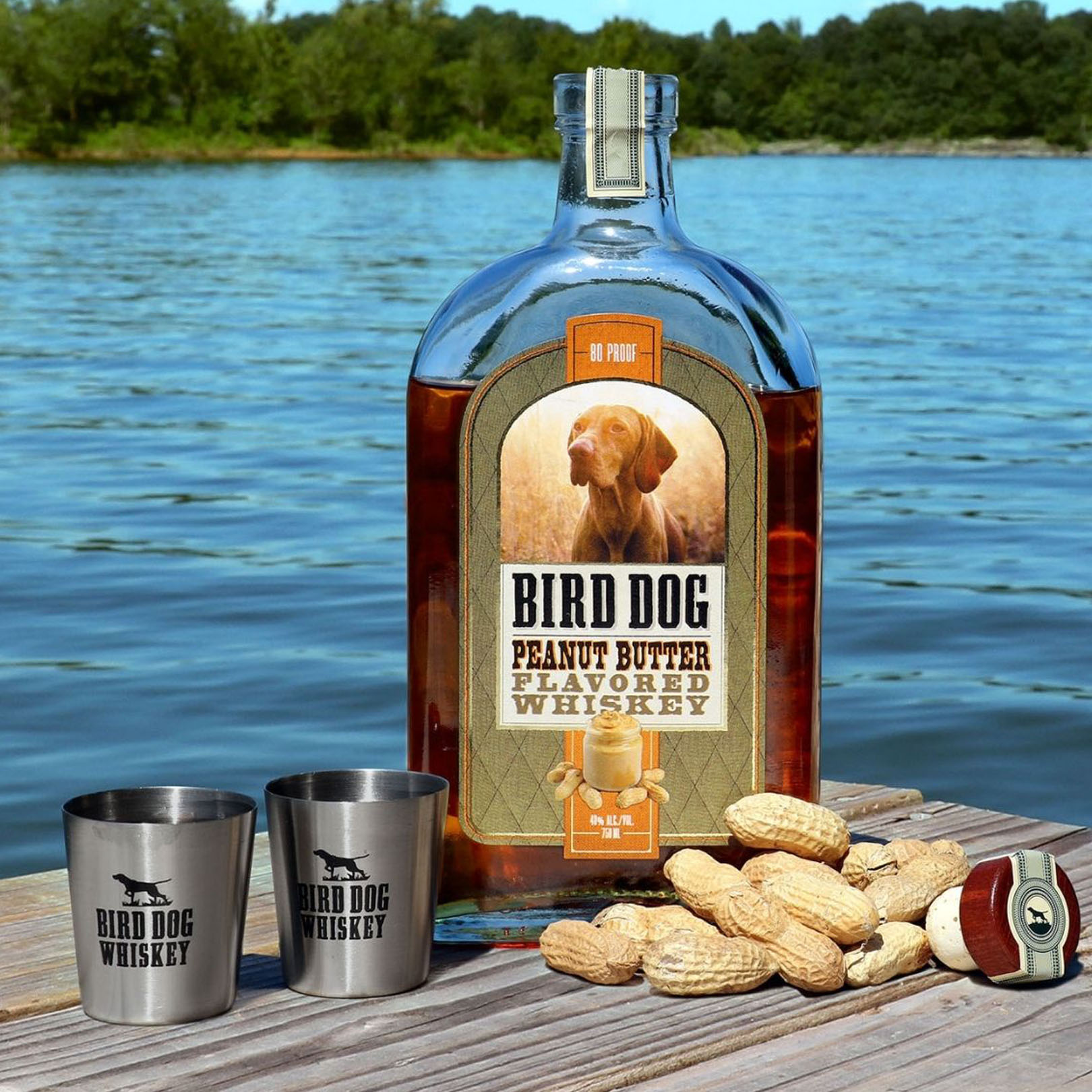 Bottle of Bird Dog Peanut Butter Whiskey Sitting on Table with Peanuts