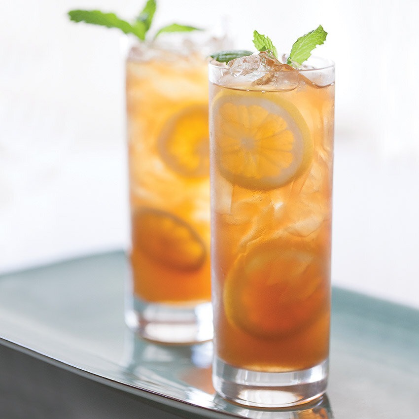 summer peach tea whiskey cocktails in a glass
